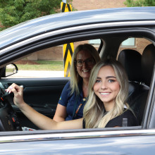 Sarah King and Jenny Iszakovits, OT, in a specialized car