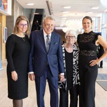 The Fleming family stand smiling at the camera