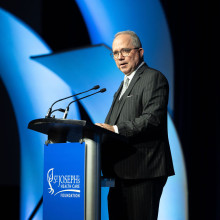 Roy Butler stands and speaks at the podium