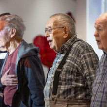 Veterans stand to sing the national anthem