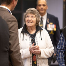 A guest enters the event with a big smile