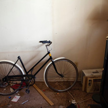 A bike in a cluttered and messy room